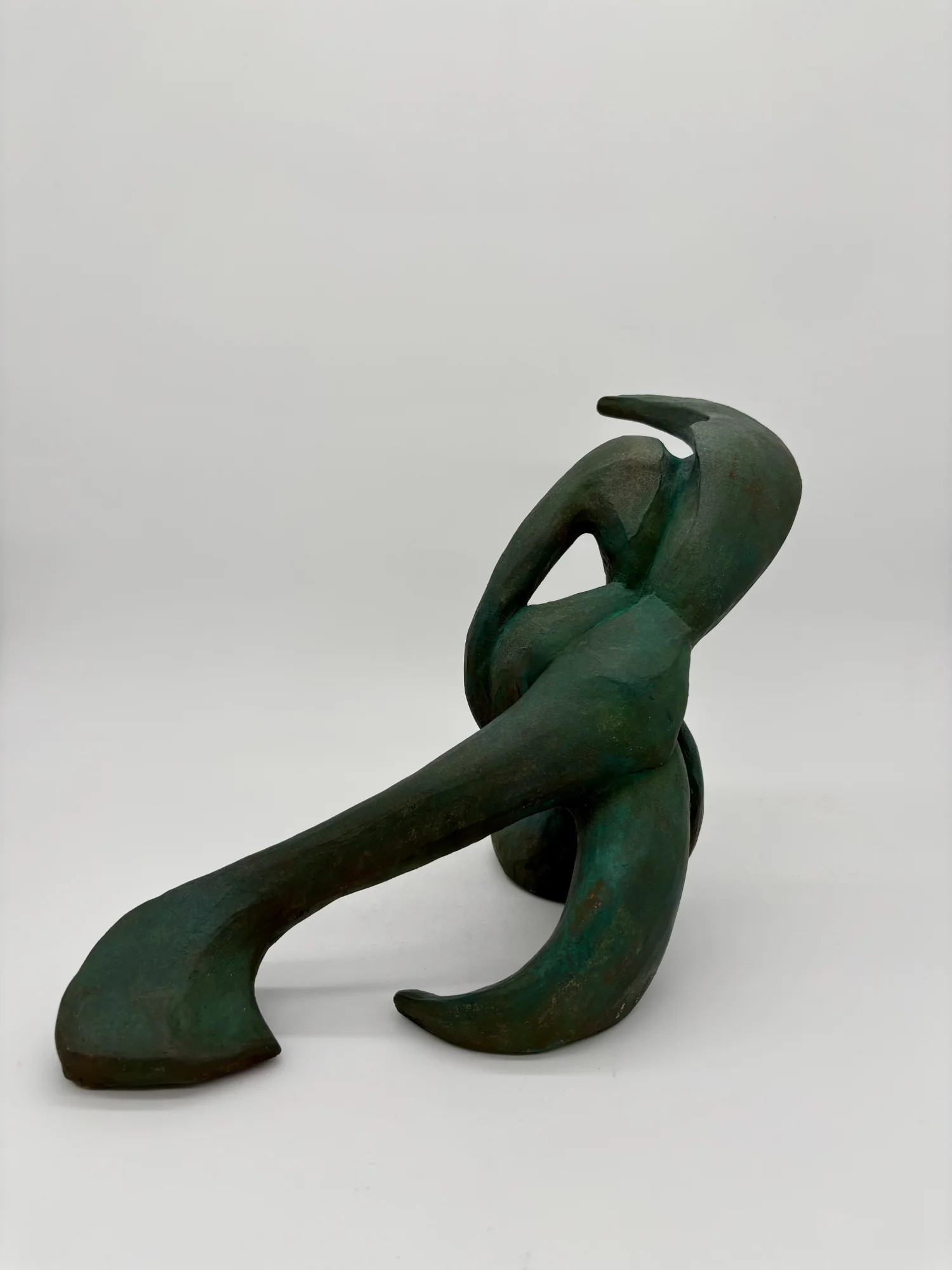 Sculpture en terre cuite évoquant un corps en mouvement avec des lignes épurées et des courbes, un jeu de pleins et de vides